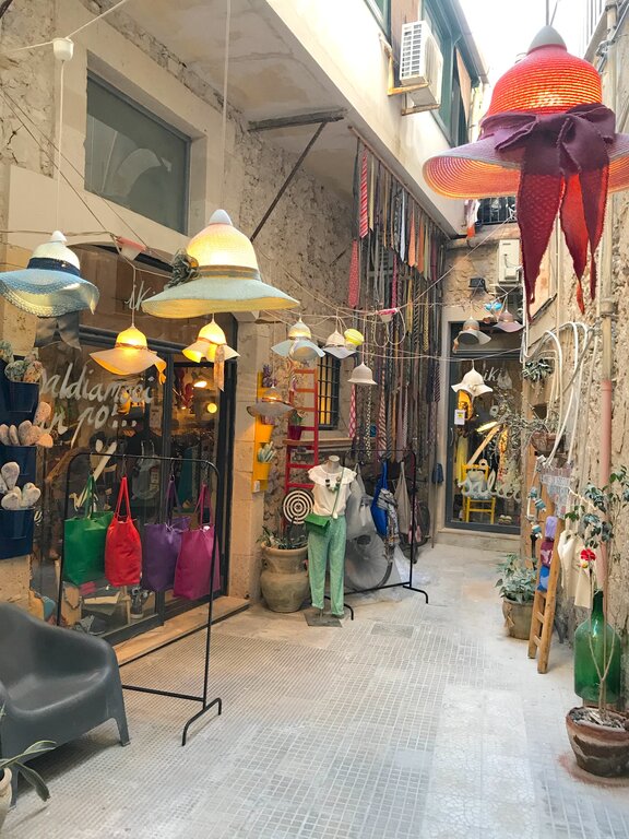 A street with goods outside in Ortigia Sicily - Shopping in Syracuse