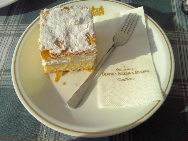 Kremna Rezina (Bled cream cake) on a plate with a fork