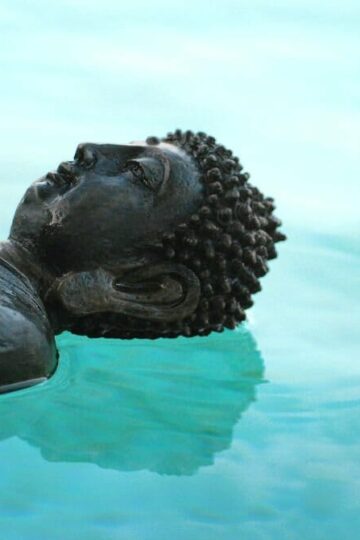 Statue of Buddha lying in water — wellness holidays