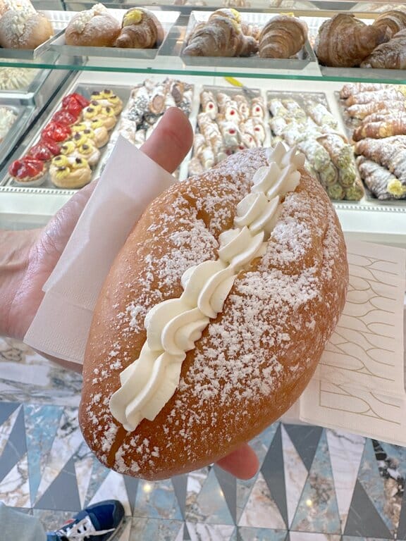 Holding a maritozzo in a pasticceria in Amalfi Italy
