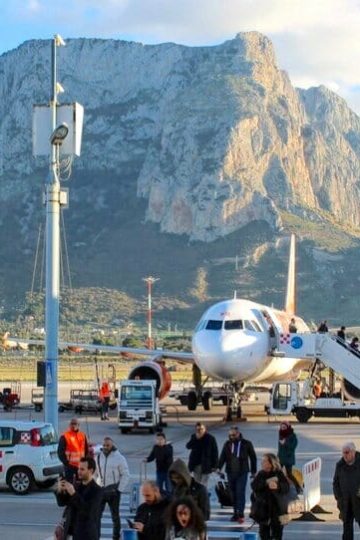 People departing the plane in Palermo Airport