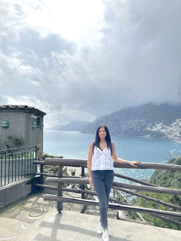 Lisa Rivera standing at a panoramic viewing point on the Amalfi Coast