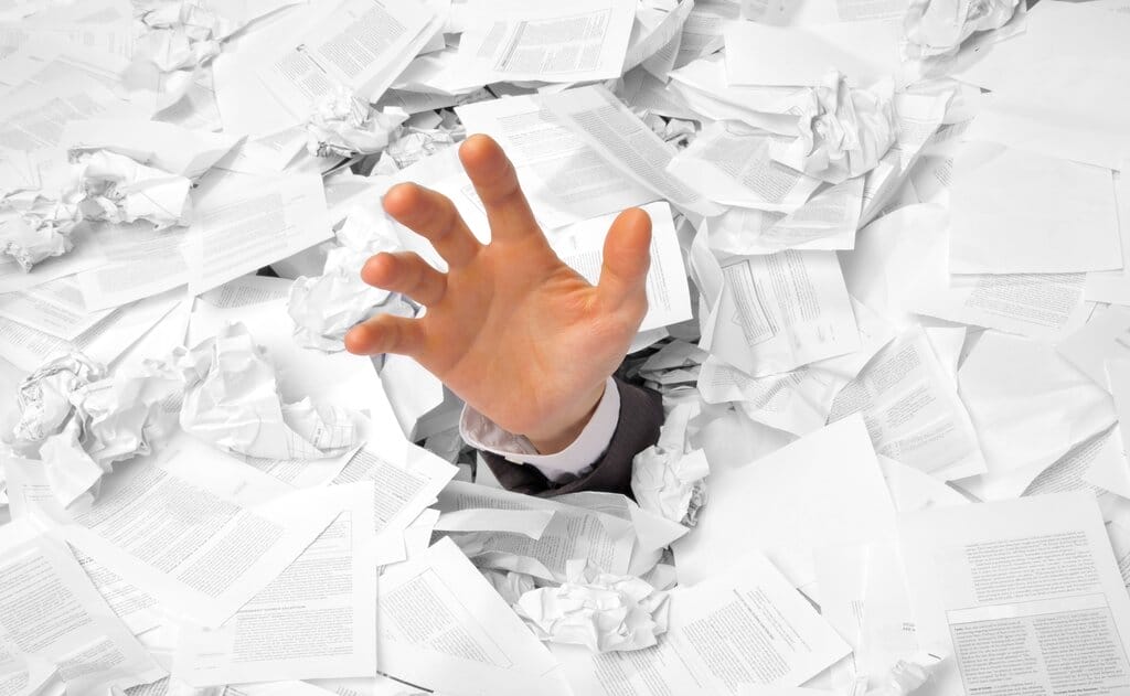 A hand drowning in paperwork - what I don't like about living in Italy