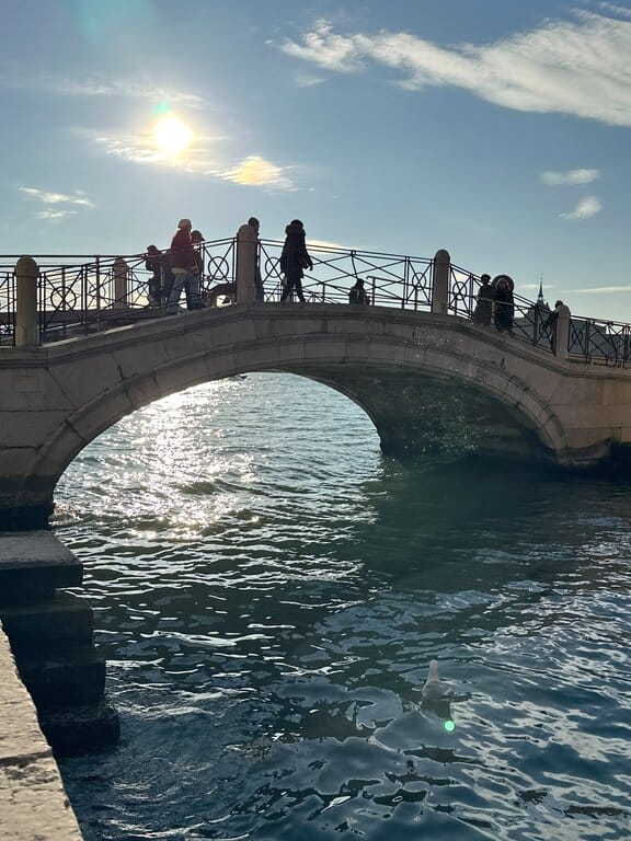 People walking over a bridge in Venice Italy — Venice Airport hotels