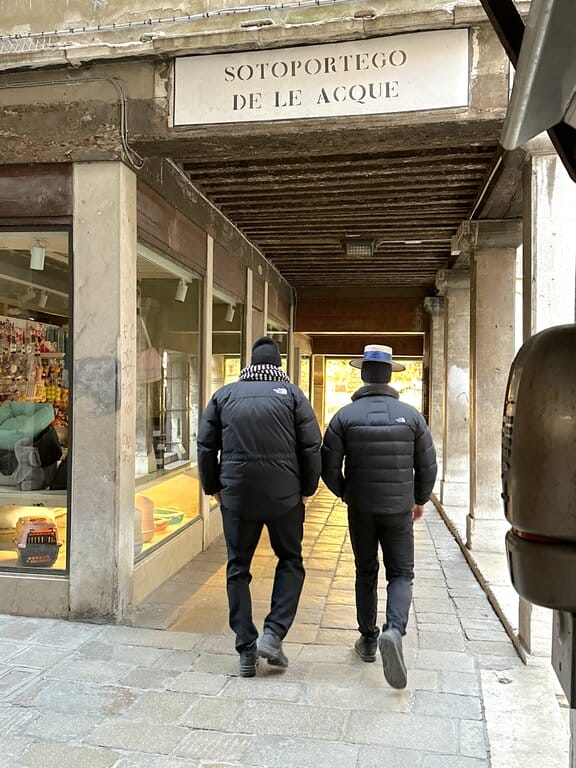 Two gondoliere walking in Venice Italy