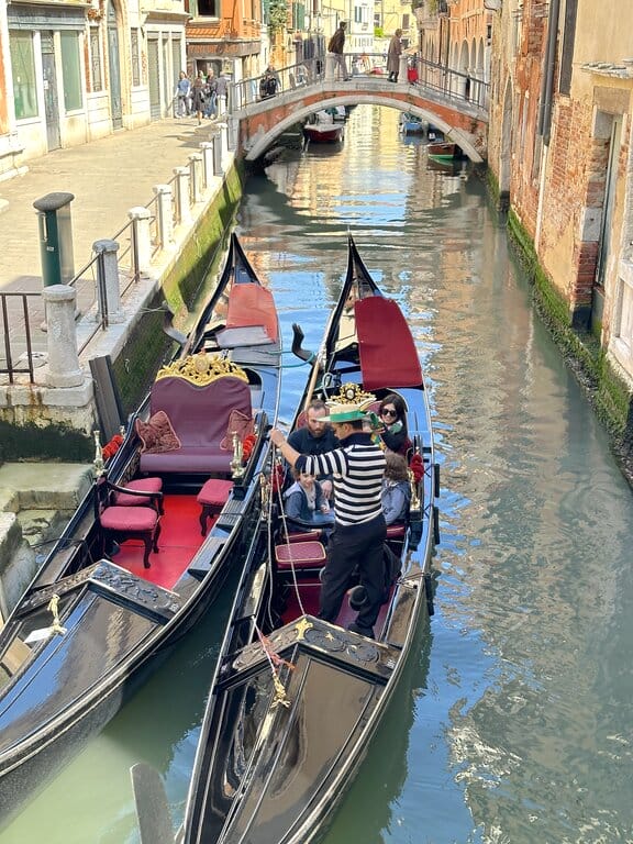 Visitors in a gondola in Venice Italy