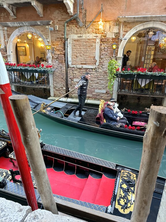 View of a gondoliere and passengers in a gondola in Venice Italy