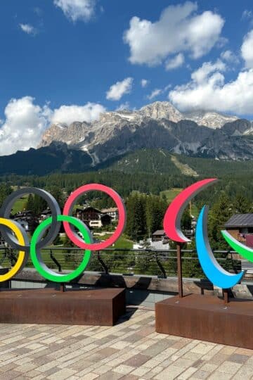 Olympic rings display with a panoramic mountain view in Cortina d'Ampezzo, Dolomites, Italy