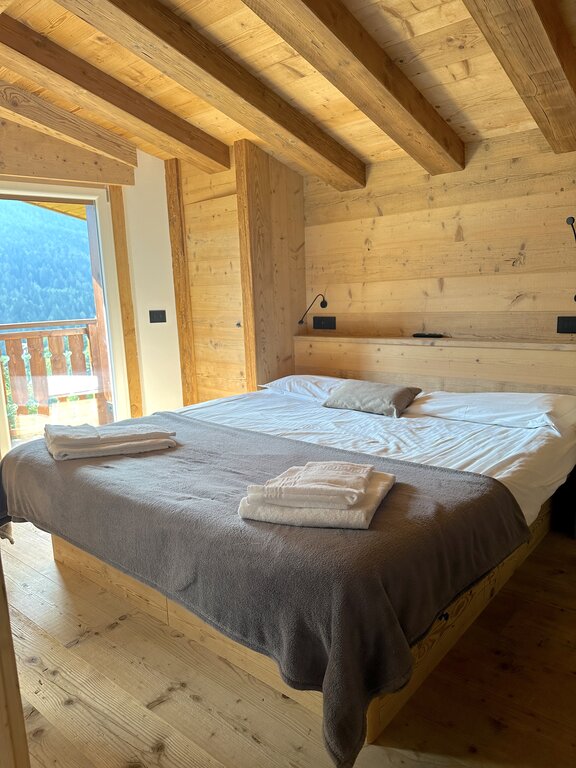 Bedroom at Lino Deluxe Suite in Borca di Cadore - where to stay in the Dolomites