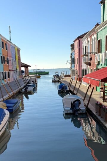 Boats on the water on a canal in Burano - how to get from Venice to Burano Italy