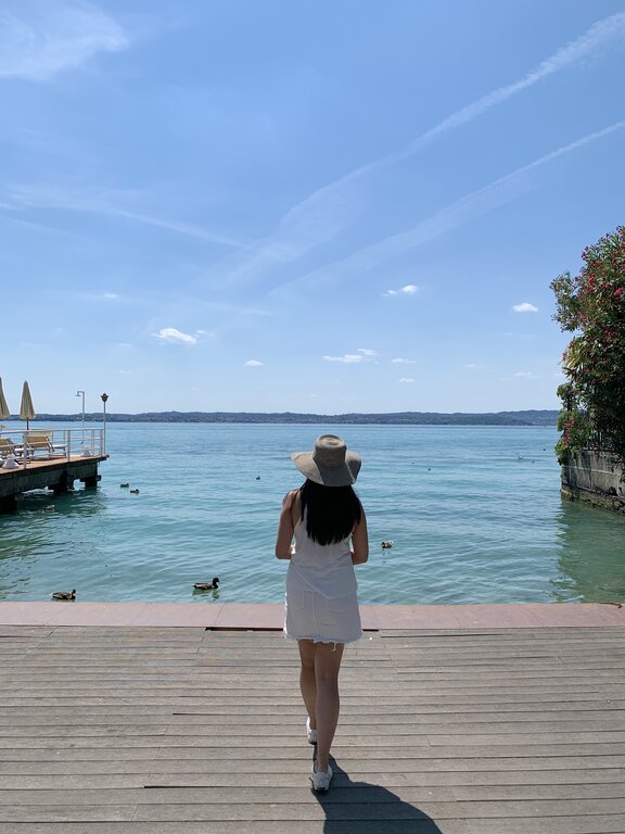 Lisa Rivera walking to shore in Sirmione Lake Garda