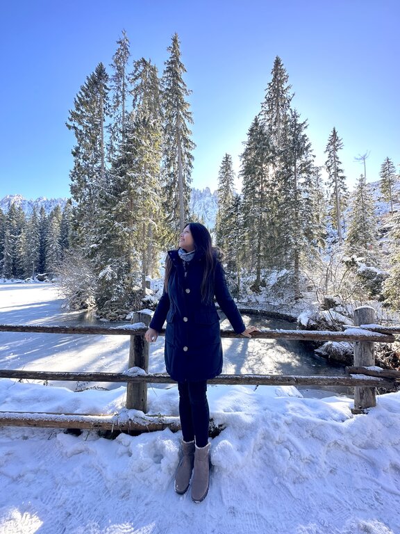 Lisa Rivera standing by Lake Carezza, The Dolomites, in December - what to wear in Italy in winter
