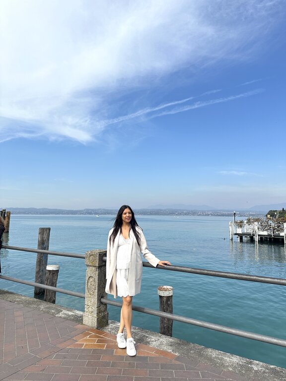 Lisa Rivera standing in Sirmione, Lake Garda in April - what to wear in Italy in April