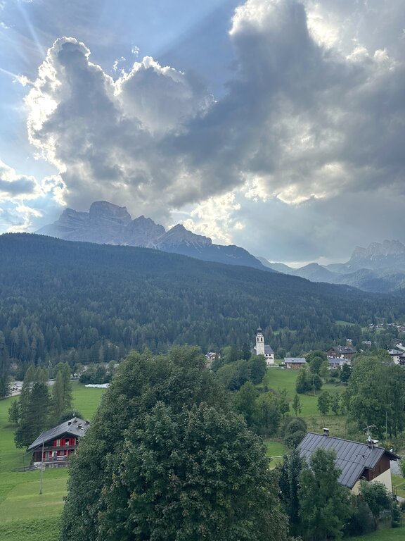 Clouds forming over a town in the Dolomites Italy in September
