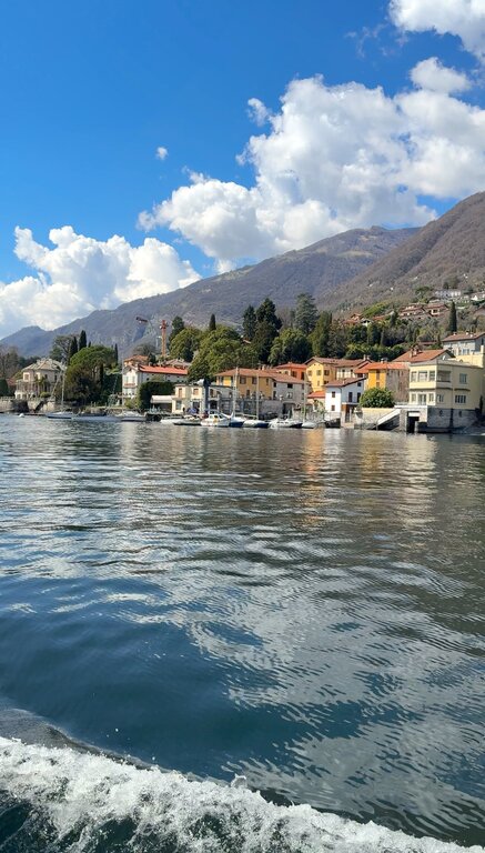 View of houses and boats in Cernobbio from Lake Como