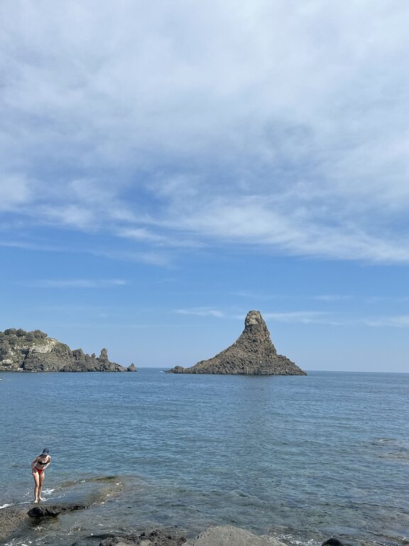 Woman on the beach at Aci Trezza Sicily Italy - southern Italy weather September