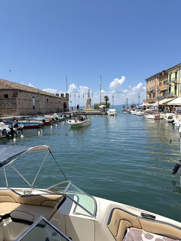 Boats coming into Lazise Harbor - Lake Garda Italy weather