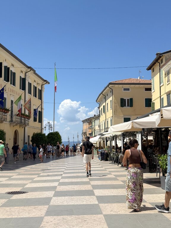 People walking in Piazza Vittorio Emanuele in Lazise - Lake Garda weather in July