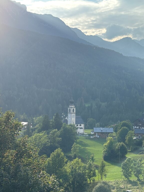 A view of a church and houses in The Dolomites Italy