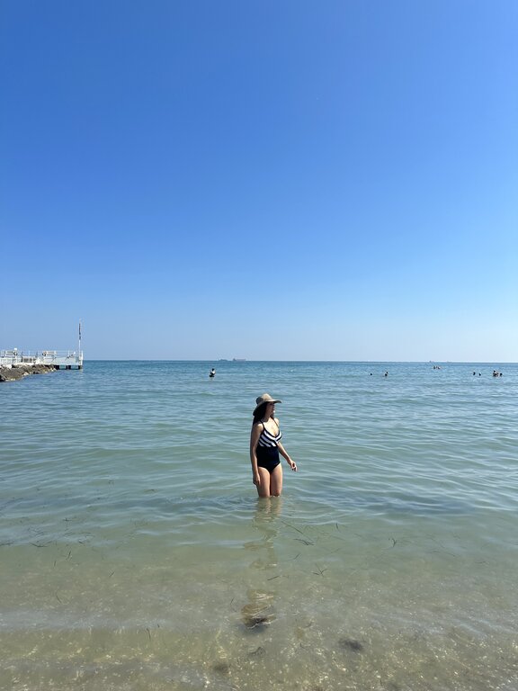 Lisa Rivera standing in the Adriatic Sea in Lido di Venezia