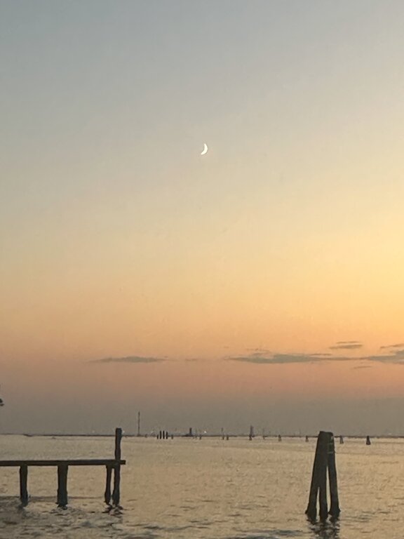 The moon at sunset in Lido of Venice Italy