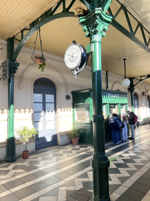 Passengers at a kiosk outside Taormina-Giardini train station, the regional rail stop serving Taormina and Giardini Naxos on the Catania-Messina line